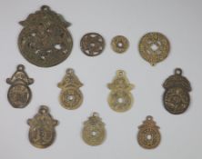 China, 11 bronze charms or amulets, Qing dynasty or earlier, including an openwork pendant charm,