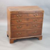 A George III mahogany chest, fitted brushing slide and four graduated long drawers, on bracket feet,