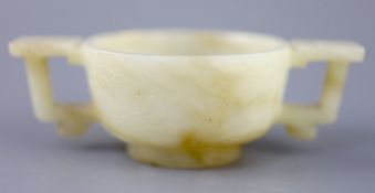 A Chinese pale celadon and russet jade cup, 17th/18th century, carved in low relief to each side