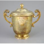 An Edwardian silver gilt-lidded two handled presentation cup and cover, by R & S Garrard and Co.