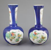 A pair of Chinese powder blue famille verte bottle vases, Kangxi period (1662-1722), each painted to