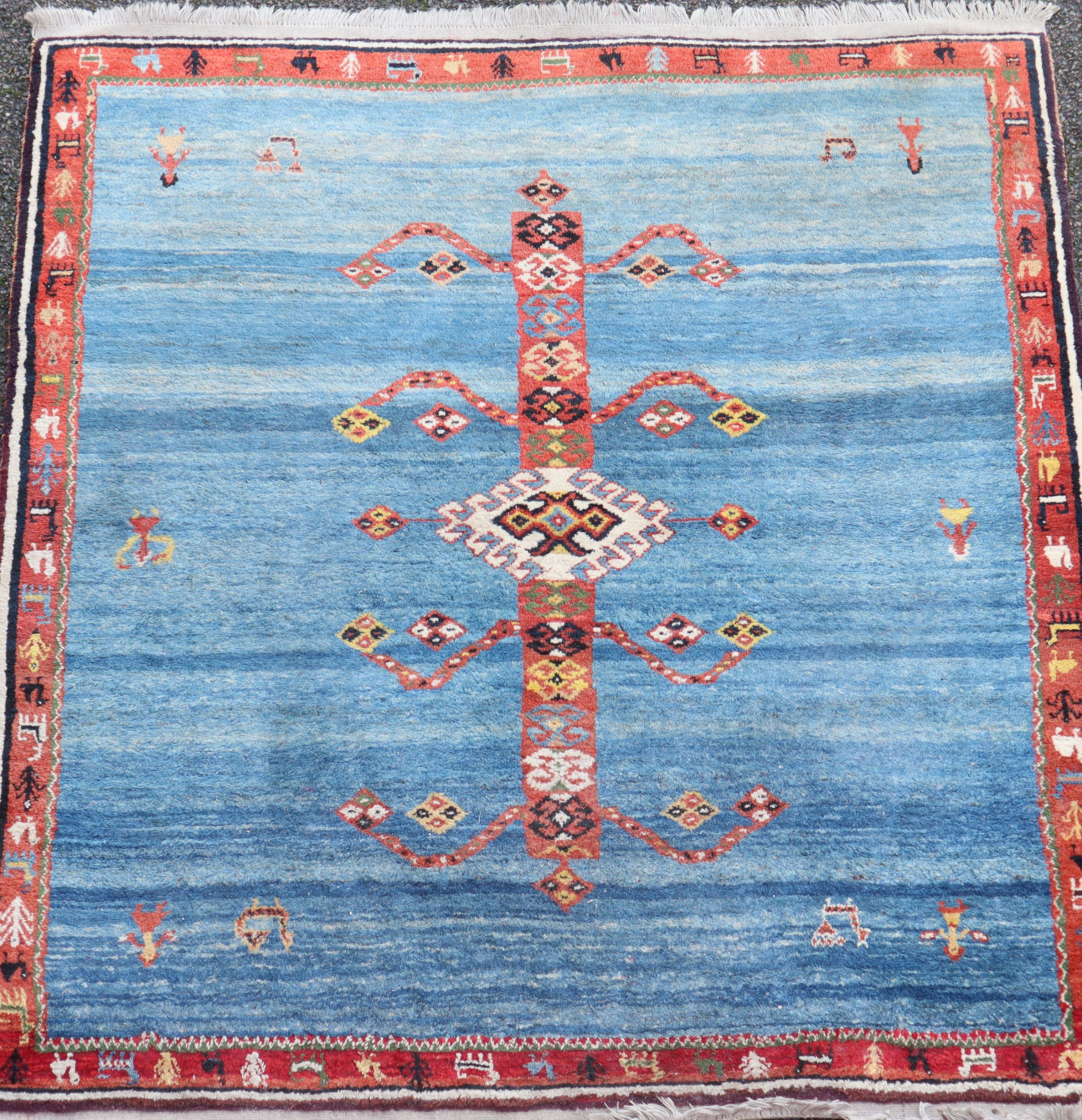 An Iranian Qushqa'i Gabbeh blue ground carpet, with central geometric motif and single row border,