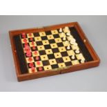 A Jaques & Son Ltd In Statu Quo bone travelling chess set, in mahogany case, c.1860, with brass