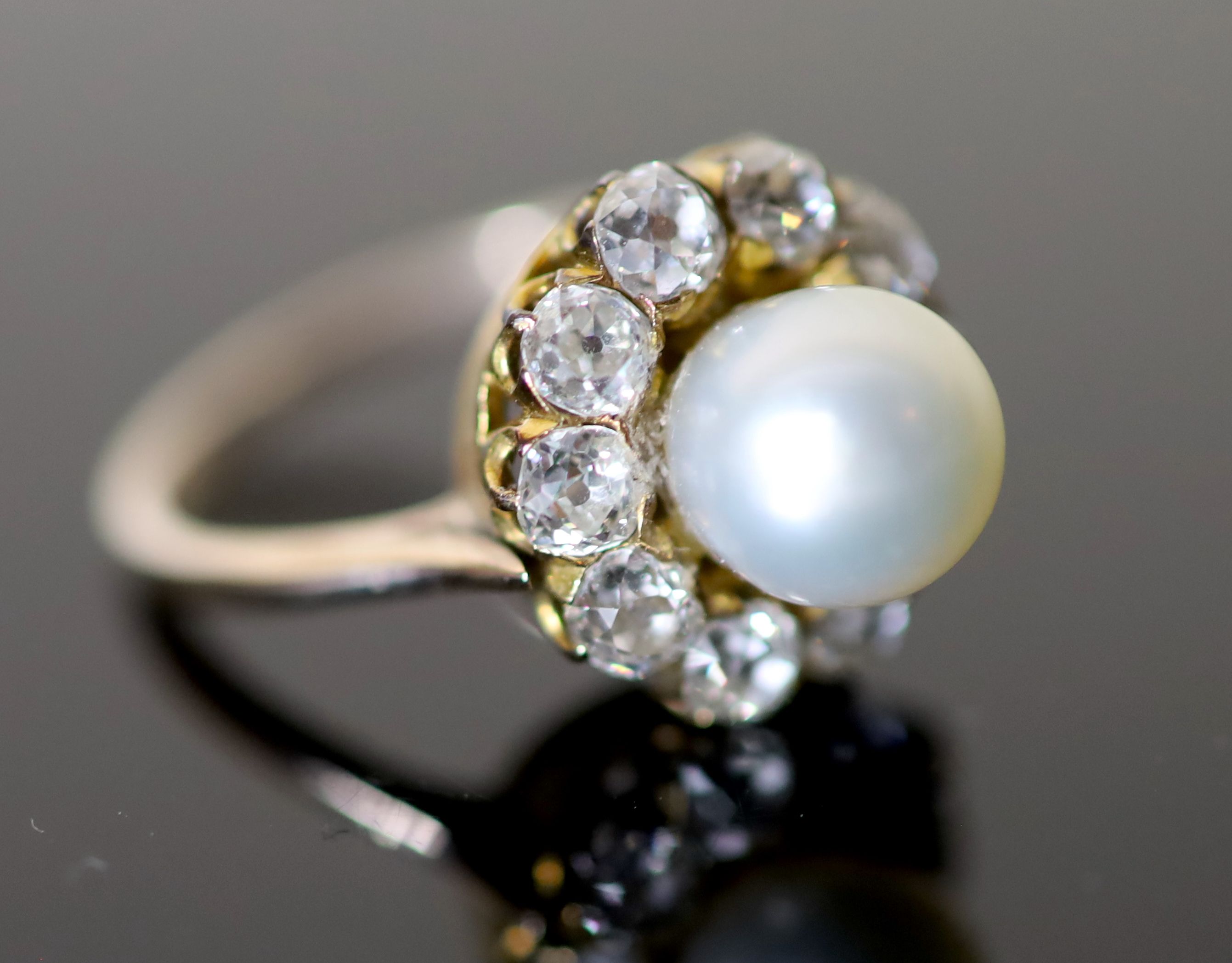 A modern gold, cultured pearl and diamond set circular cluster ring, size M, gross 4.7 grams.