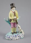 A Staffordshire pearlware group of a huntsman with dog and gun, c.1820-30, on a turquoise and blue