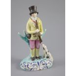 A Staffordshire pearlware group of a huntsman with dog and gun, c.1820-30, on a turquoise and blue