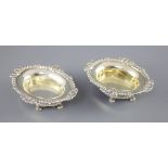 A pair of George III cast silver oval table salts by Paul Storr, with gadrooned and shell borders,