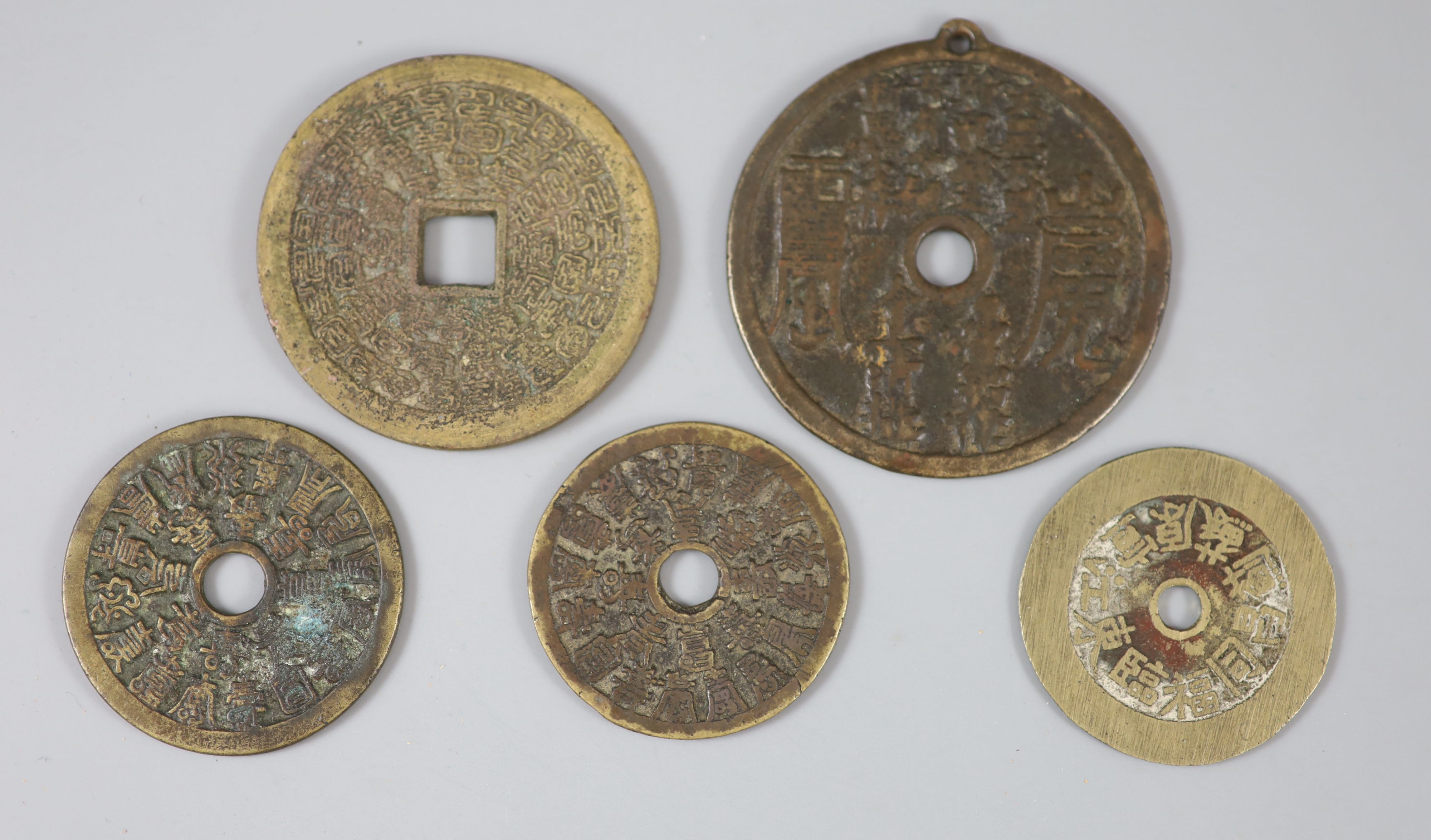 China, 5 large cast bronze charms or amulets, Qing dynasty, the first inscribed to the obverse and