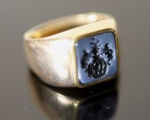An early 20th century Austro-Hungarian? gold and blue sardonyx set signet ring, the matrix carved