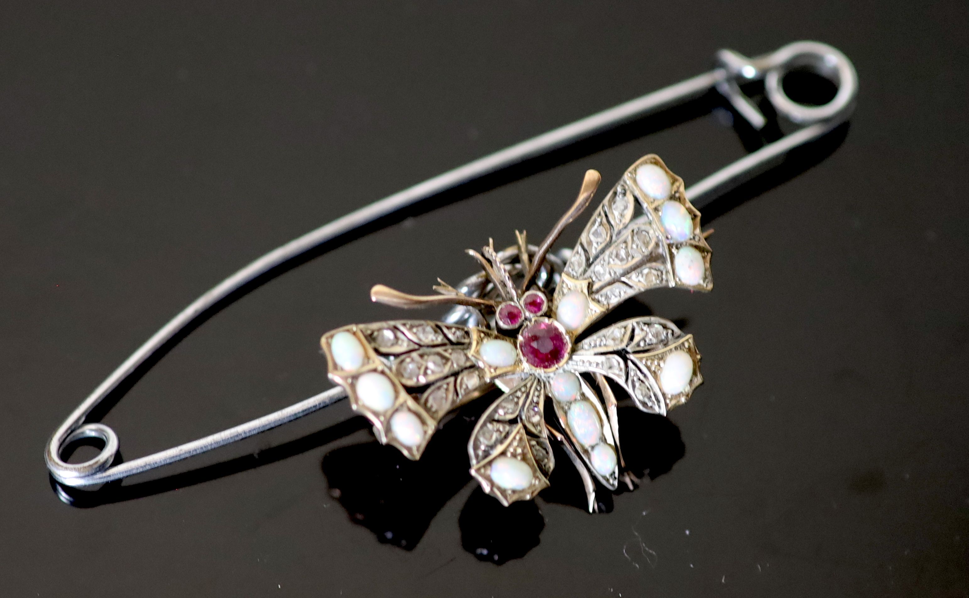 An Edwardian gold and silver, rose cut diamond, white opal and ruby set butterfly brooch, width