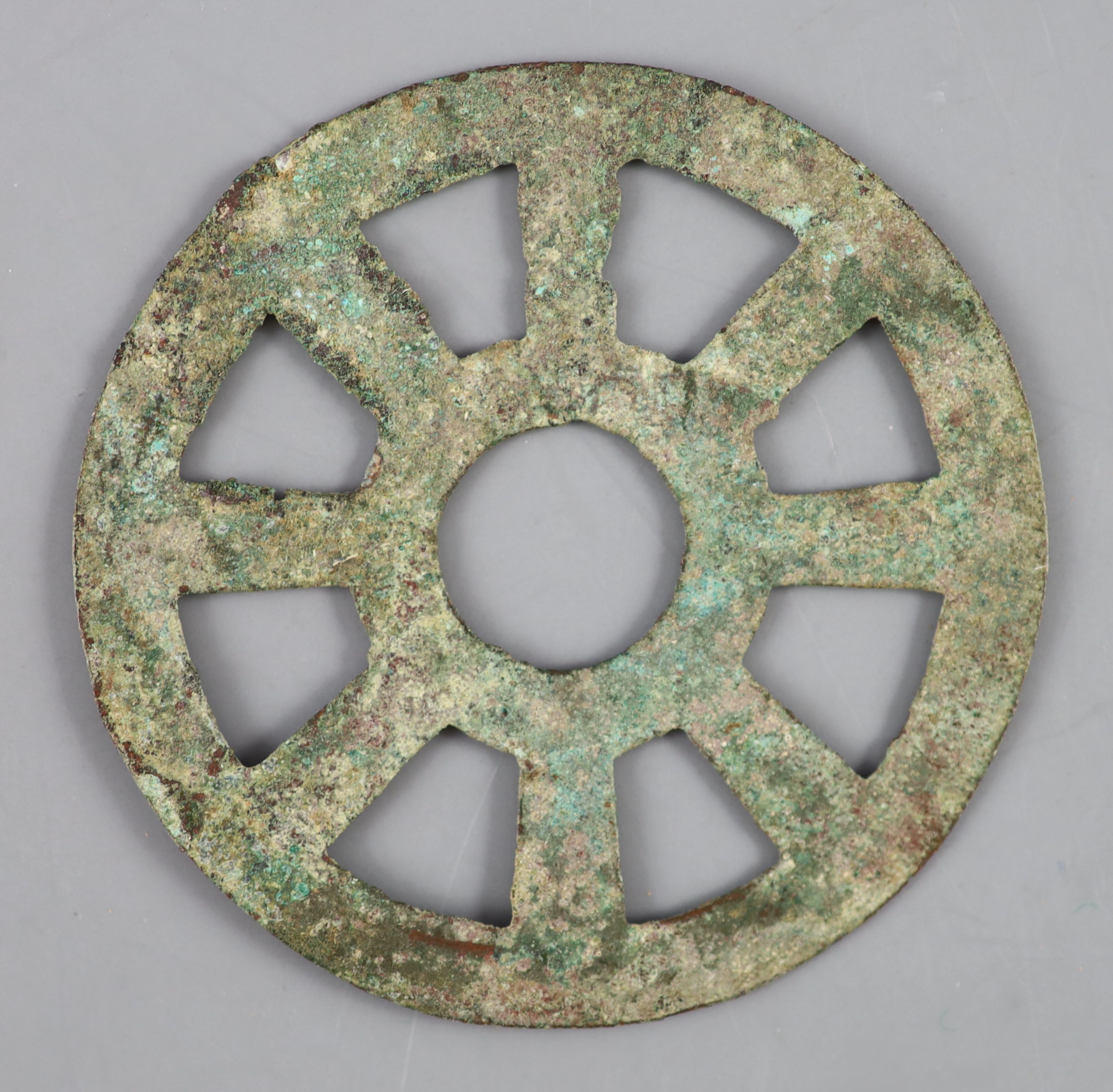 China, a rare archaic bronze openwork Dharmachakra (wheel) charm, probably Han-Tang dynasty, 64mm, - Image 2 of 2