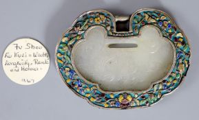 A Chinese silver and enamel mounted white jade 'spirit lock' pendant, carved in relief 'Fu Shou Lu