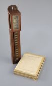 A Japanese shitan wood wall clock, shoku dokei, 19th century, 38cm high, together with a book on