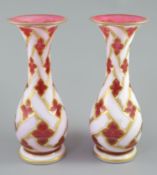 A pair of Bohemian white and ruby overlaid glass baluster vases, late 19th century, decorated with