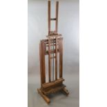 A Roberson & Co oak studio easel, with twin cranked telescopic height adjustment and ivory label