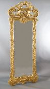 A late 19th century French carved giltwood wall mirror, of generous proportions, decorated with