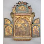 A 19th century Russian tempera on wood triptych icon, c.1800 with floral and bird carved crest,