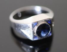 A platinum and single stone synthetic? sapphire set dress ring, with four shaped cut synthetic?