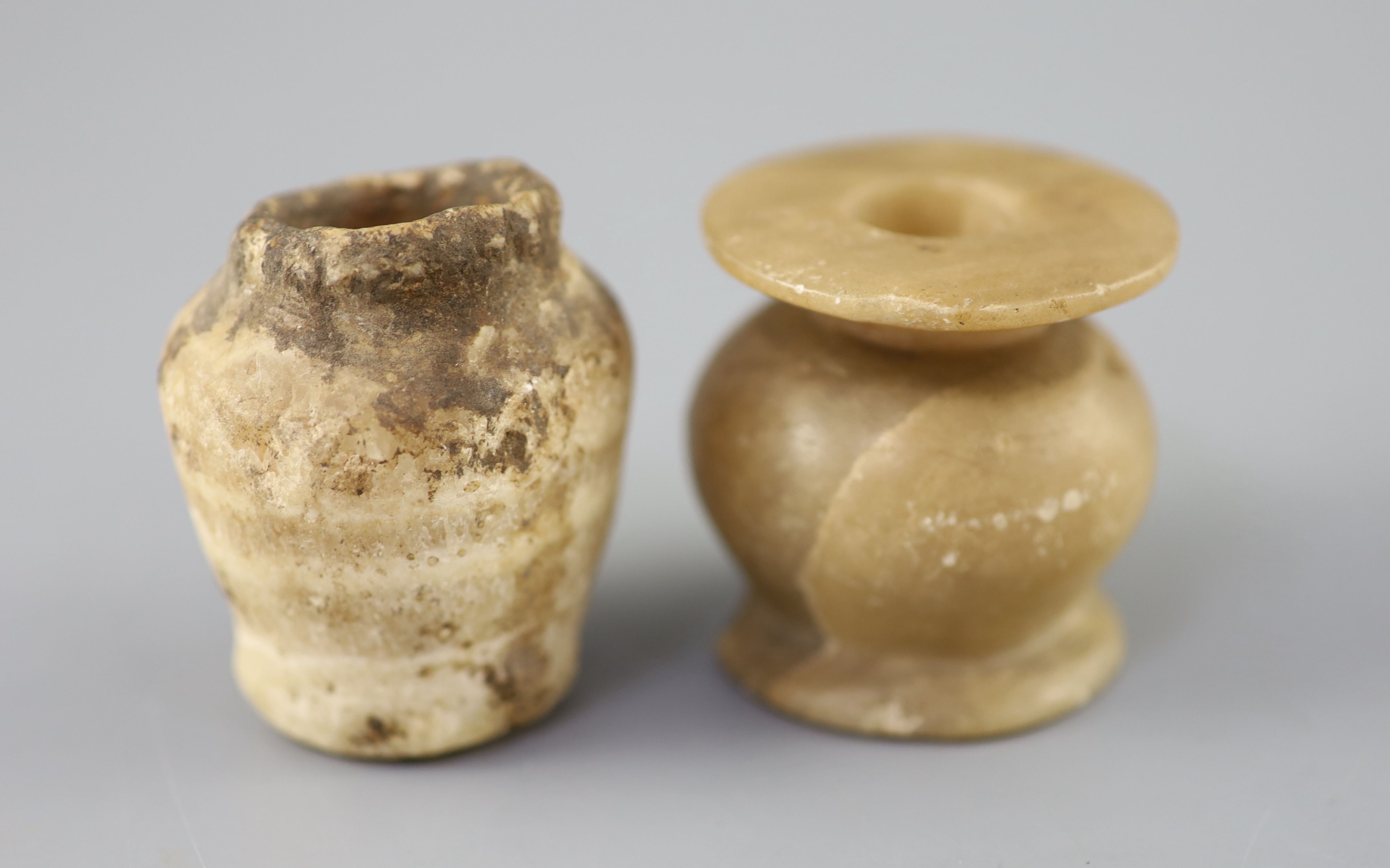 Two Egyptian alabaster cosmetic jars, c.1500 BC and Ptolemaic period (305-30 BC), the older jar with