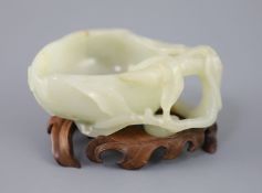 A Chinese pale celadon jade 'peach' brush washer, 17th/18th century carved in high relief and