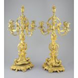 A pair of late 19th century French Louis XV style ormolu seven light candelabra, with foliate scroll