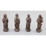 Four English oak figures of Evangelists, three possibly c.1425-50, one a 19th century copy, from