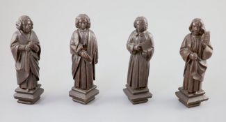 Four English oak figures of Evangelists, three possibly c.1425-50, one a 19th century copy, from