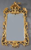 A George III Chippendale style carved giltwood wall mirror, with stylised arched crest centred