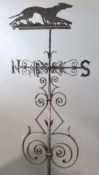 A large Victorian black painted wrought iron weather vane, surmounted with a running hound, with