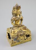 A Chinese gilt bronze seated figure of Amitayus, Qianlong period, dated 1770, the crowned figure