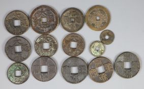 China, a group of 14 bronze coin charms or amulets, Qing dynasty, variously inscribed - two Tai Ping