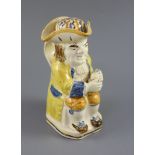 A Staffordshire Prattware 'Good Hearty Fellow' Toby jug with rare hat measure, c.1790-1800, on a