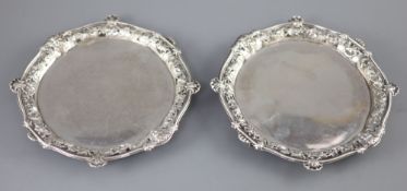 A good pair of George II silver card trays by George Wickes, of shaped circular form, with pierced