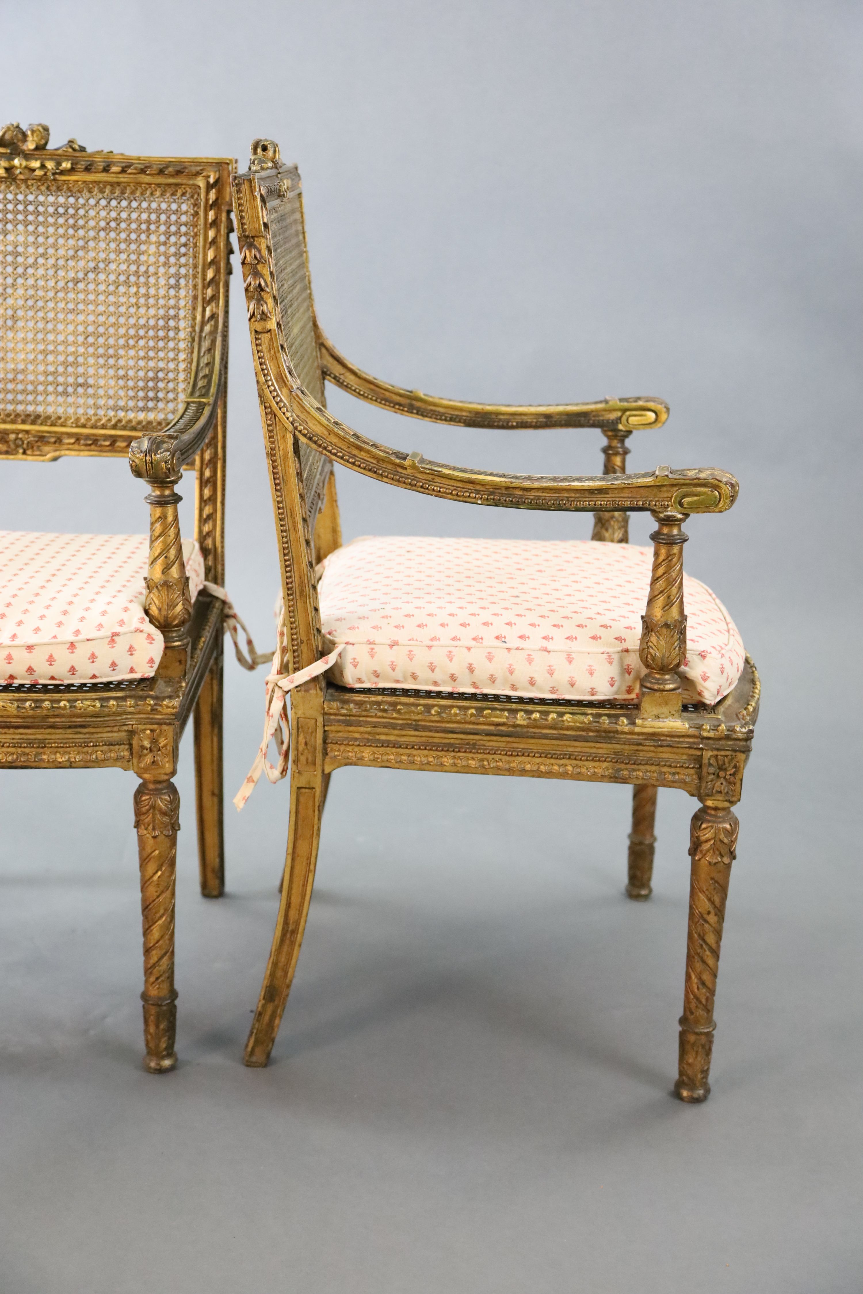 A pair of Louis XVI style walnut giltwood fauteuils, with flower and ribbon carved frames, caned - Image 4 of 4