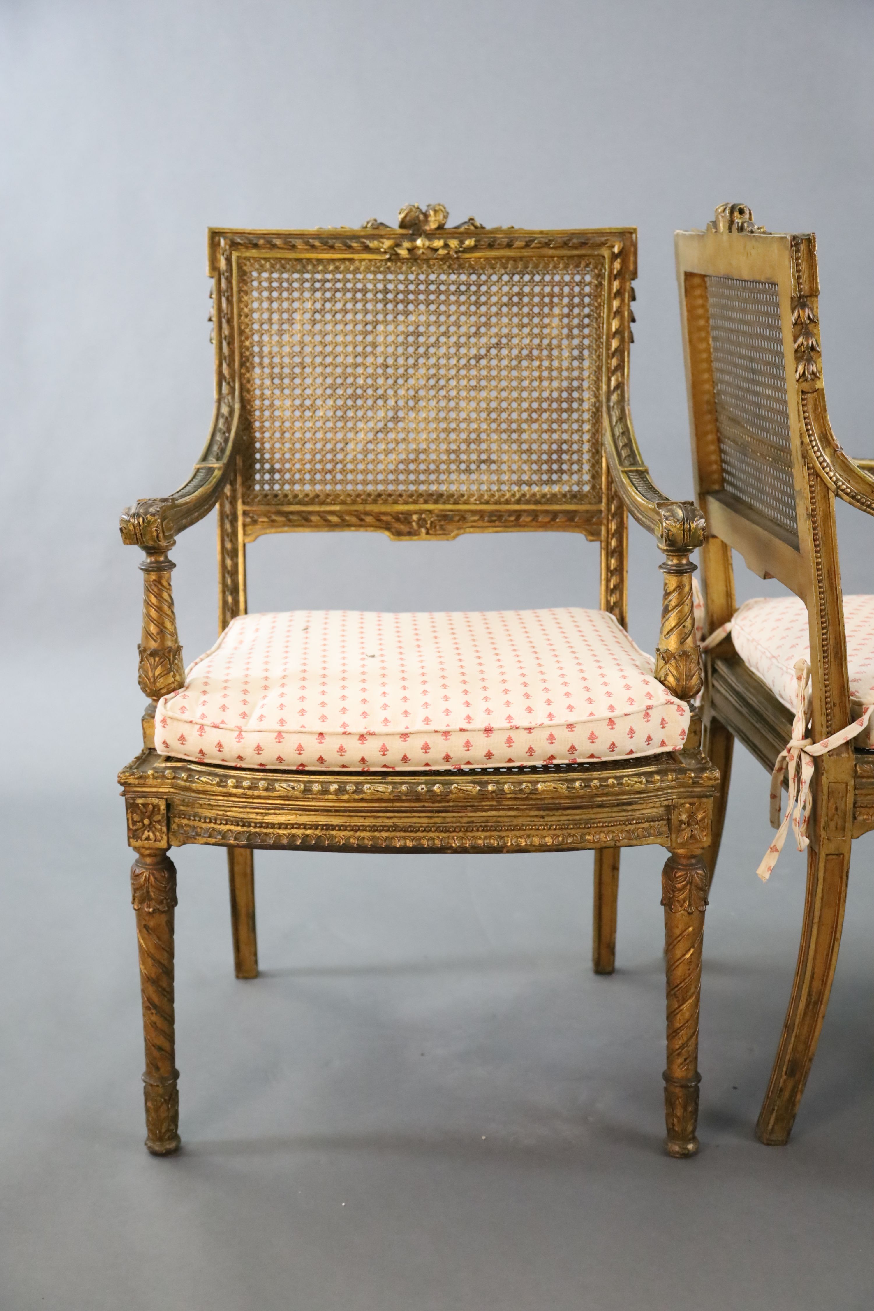 A pair of Louis XVI style walnut giltwood fauteuils, with flower and ribbon carved frames, caned - Image 3 of 4