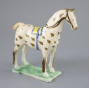 Attributed to St. Anthony Pottery, Newcastle, a pearlware figure of a racehorse with yellow