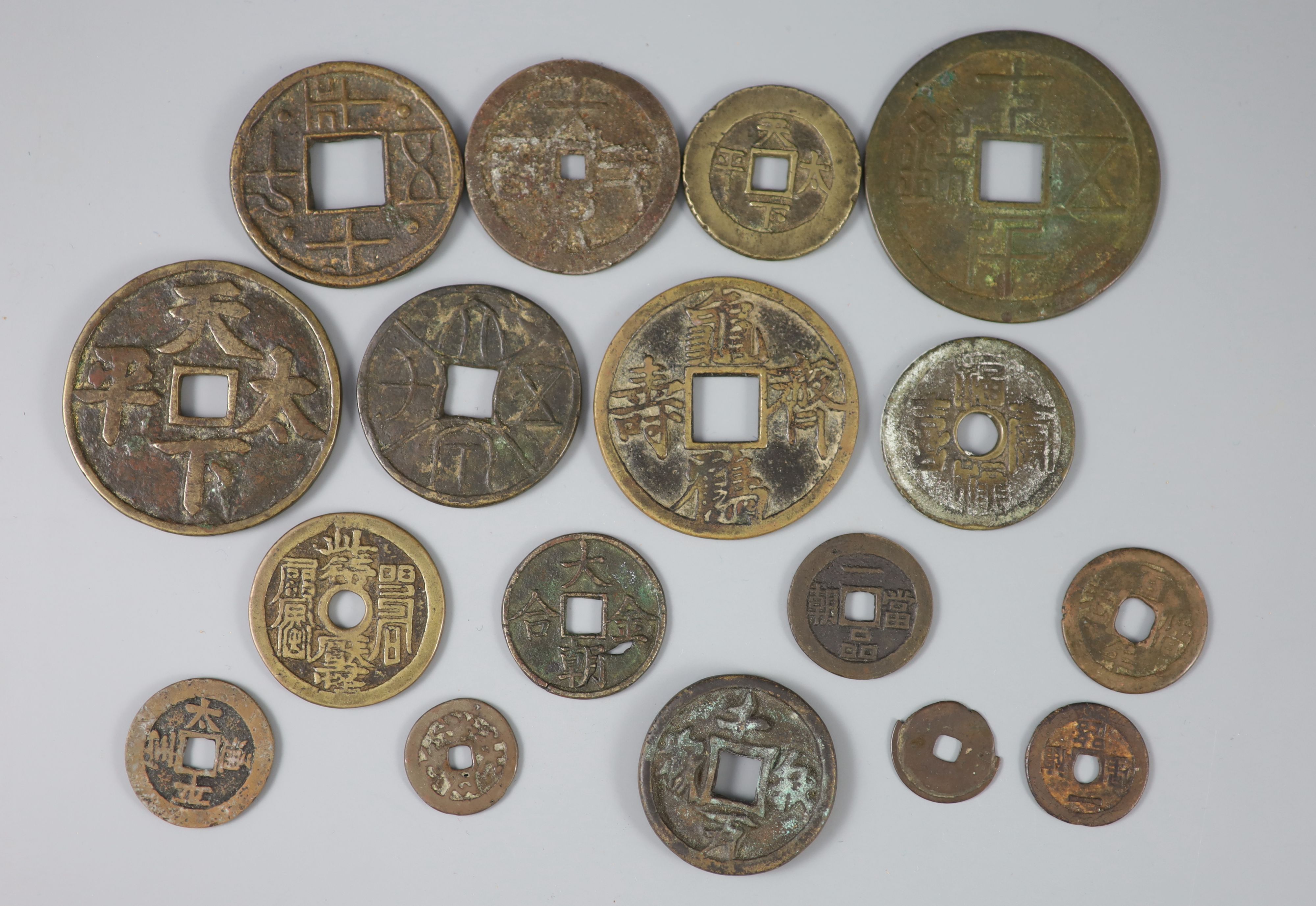 China, a group of 17 bronze or copper inscribed charms or amulets, Qing dynasty, nine with