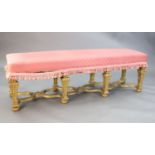 A Louis XIV style carved giltwood stool, with upholstered seat and scroll and harebell carved