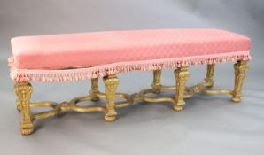 A Louis XIV style carved giltwood stool, with upholstered seat and scroll and harebell carved