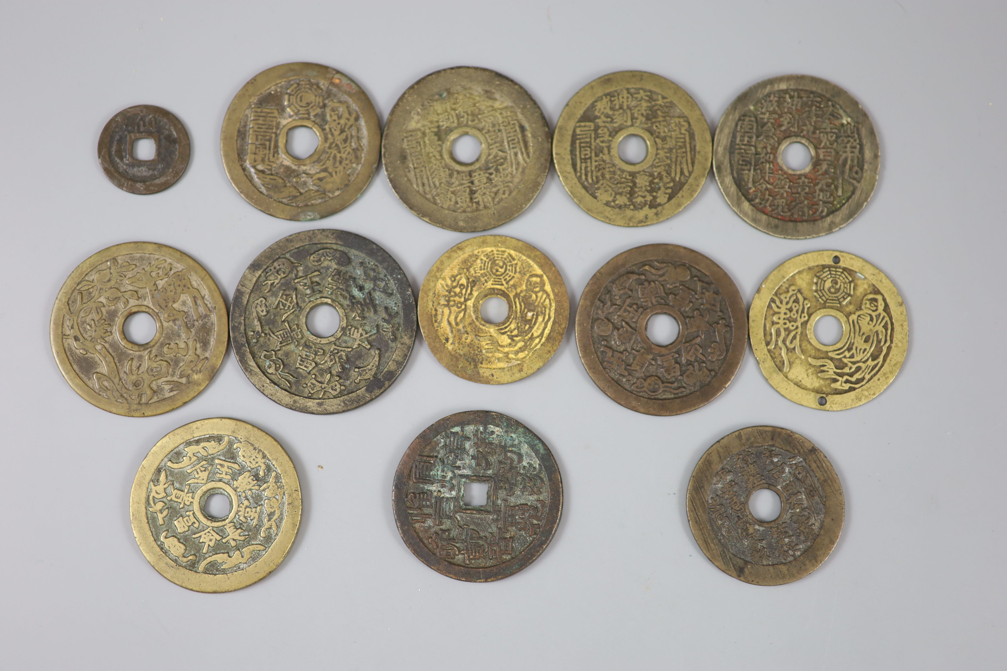 China, 12 cast bronze charms or amulets, Qing dynasty, seven inscribed 'Tai Shang zhou yue..', - Image 2 of 2