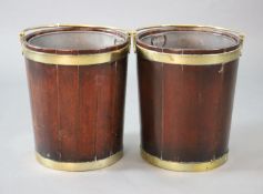 A pair of George III brass bound mahogany peat buckets, with swing handles and tin liners, W.1ft