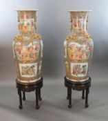 A pair of massive Chinese Canton style famille rose vases, 20th century and a pair of Chinese hongmu