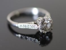 A mid 20th century white gold and single stone diamond ring, with diamond set shoulders, the stone