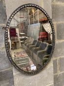 An oval Irish style wall mirror, width 48cm, height 64cm