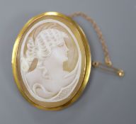 A late Victorian 9ct mounted oval cameo shell brooch, carved with the bust of a lady to sinister,