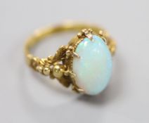 A 19th century yellow metal and oval white opal set dress ring, size M, gross 4.1 grams.CONDITION: