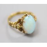 A 19th century yellow metal and oval white opal set dress ring, size M, gross 4.1 grams.CONDITION: