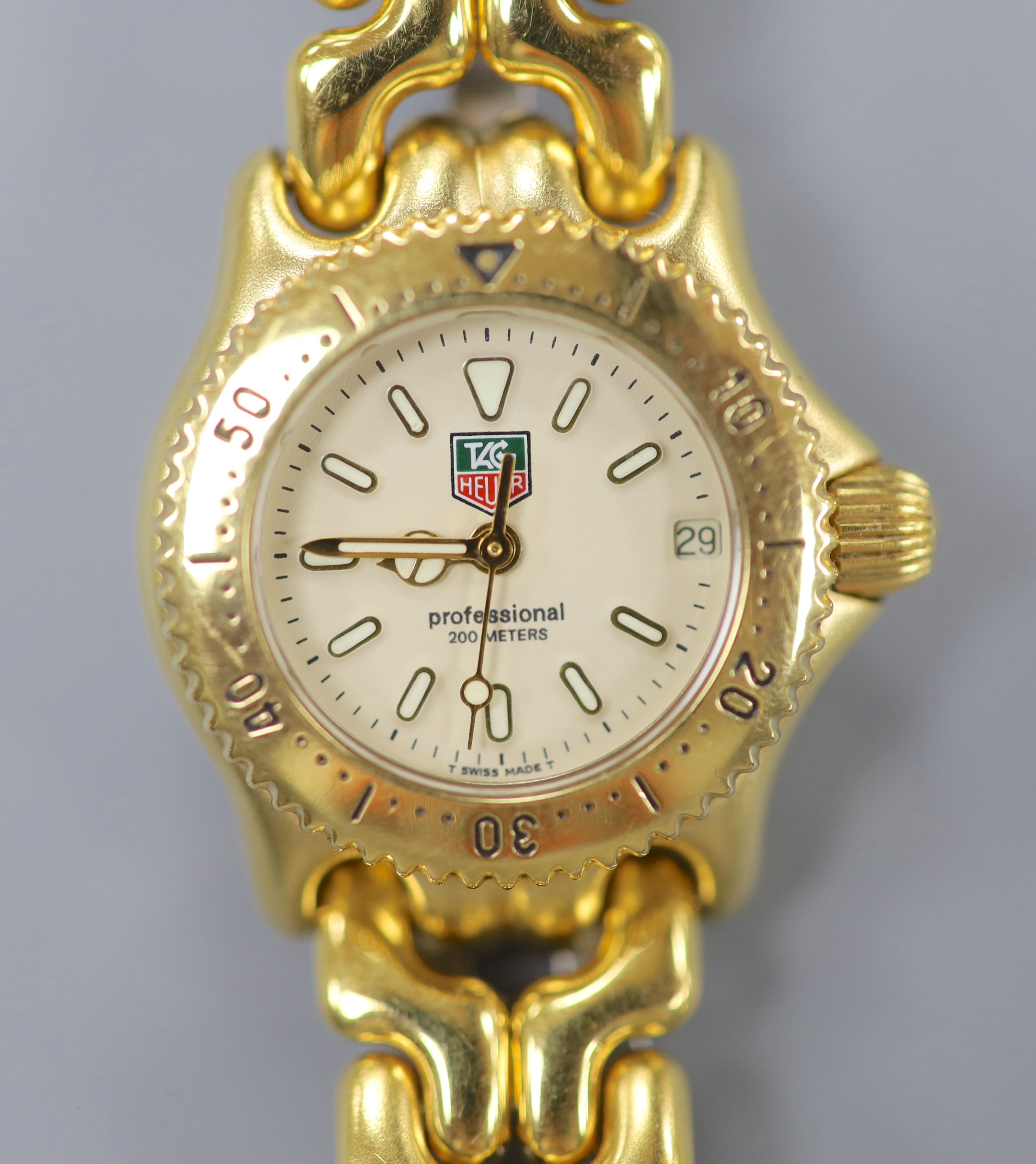 A lady's modern gilt steel Tag Heuer Professional quartz wrist watch, cased diameter 23mm, ex.