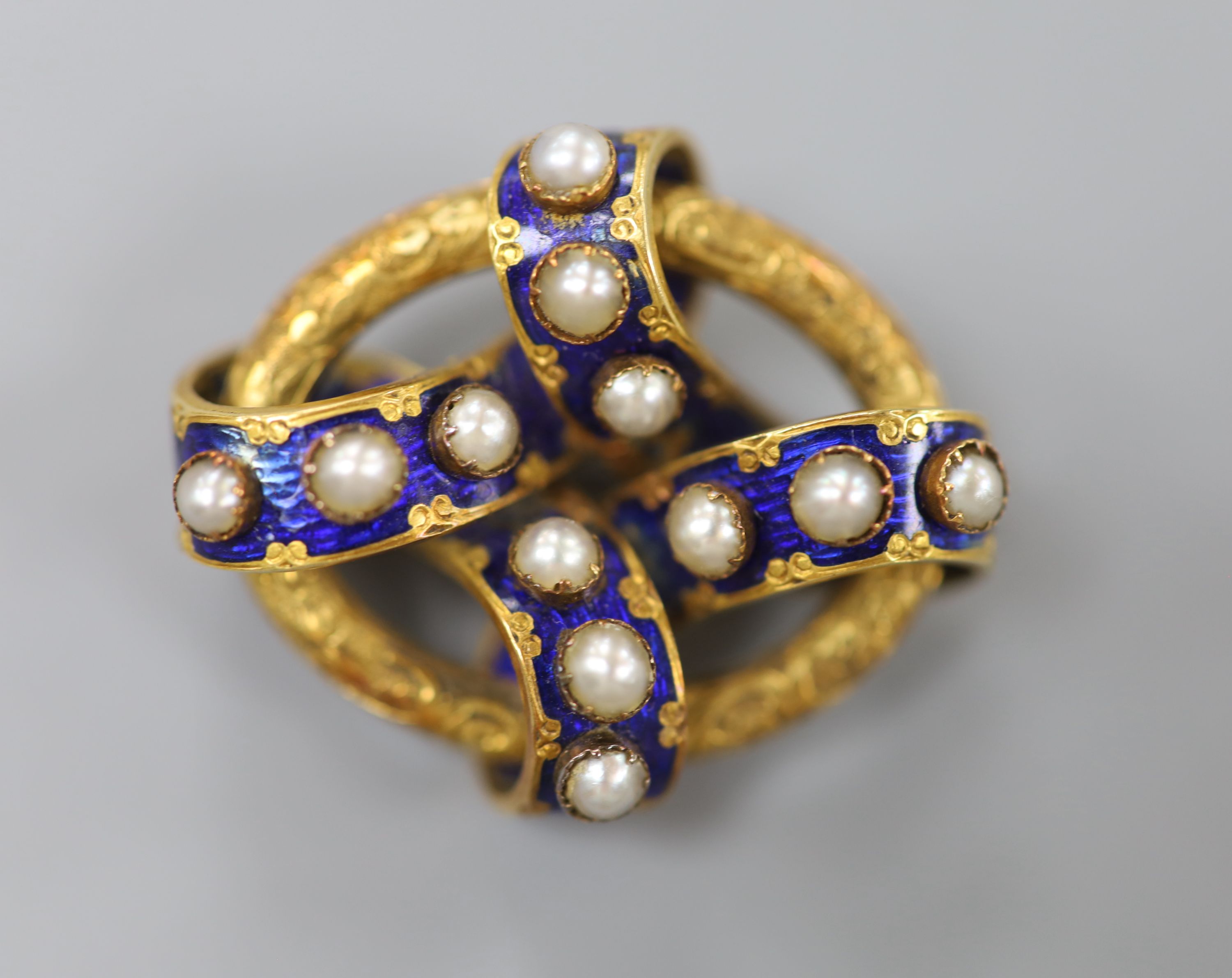 A Victorian yellow metal, blue enamel and split pearl set interwoven oval brooch, 35mm, gross 14