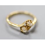 A George V 18ct gold and two stone diamond set crossover ring, size O/P, gross 2.7 grams.